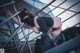A woman in a black outfit is climbing up some stairs.