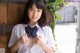 A woman in a white shirt and a blue bow tie.