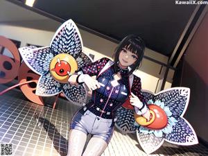 A woman in a blue and white outfit holding a red ball.