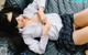 a woman laying on top of a bed with a blindfold